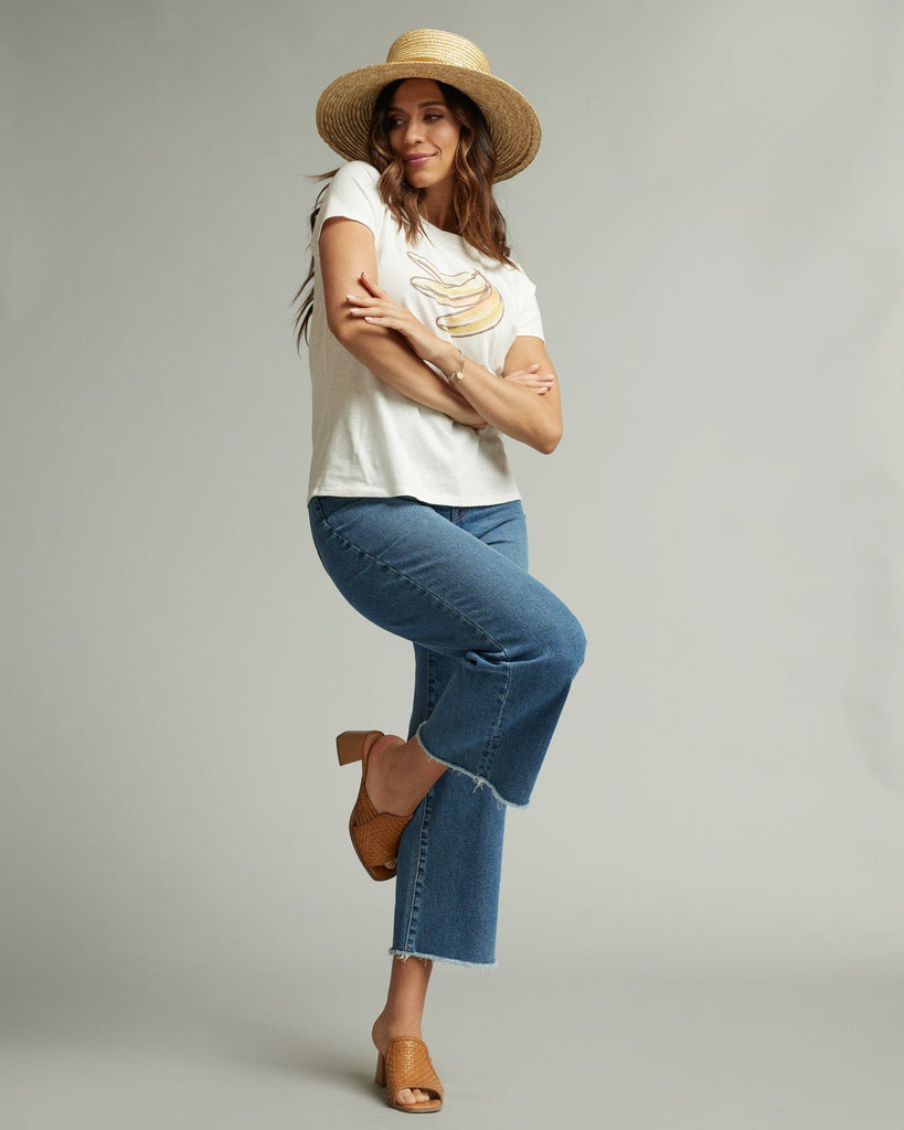 Woman in a short sleeve white graphic tee with a banana on the front