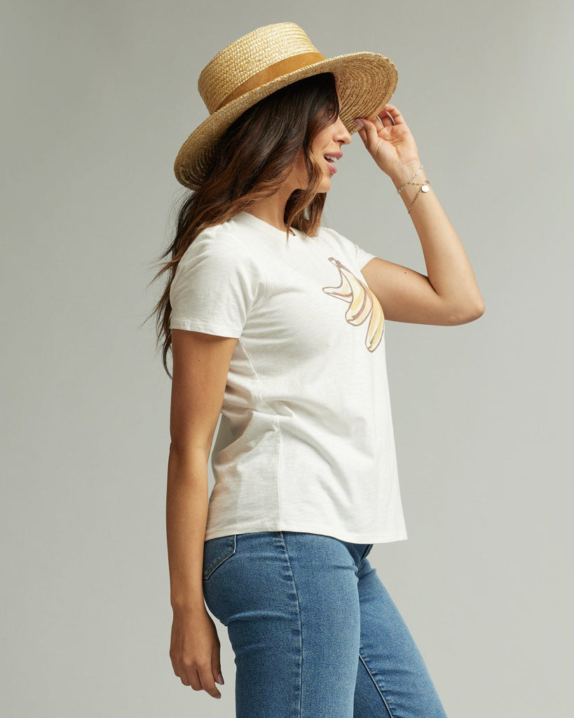 Woman in a short sleeve white graphic tee with a banana on the front