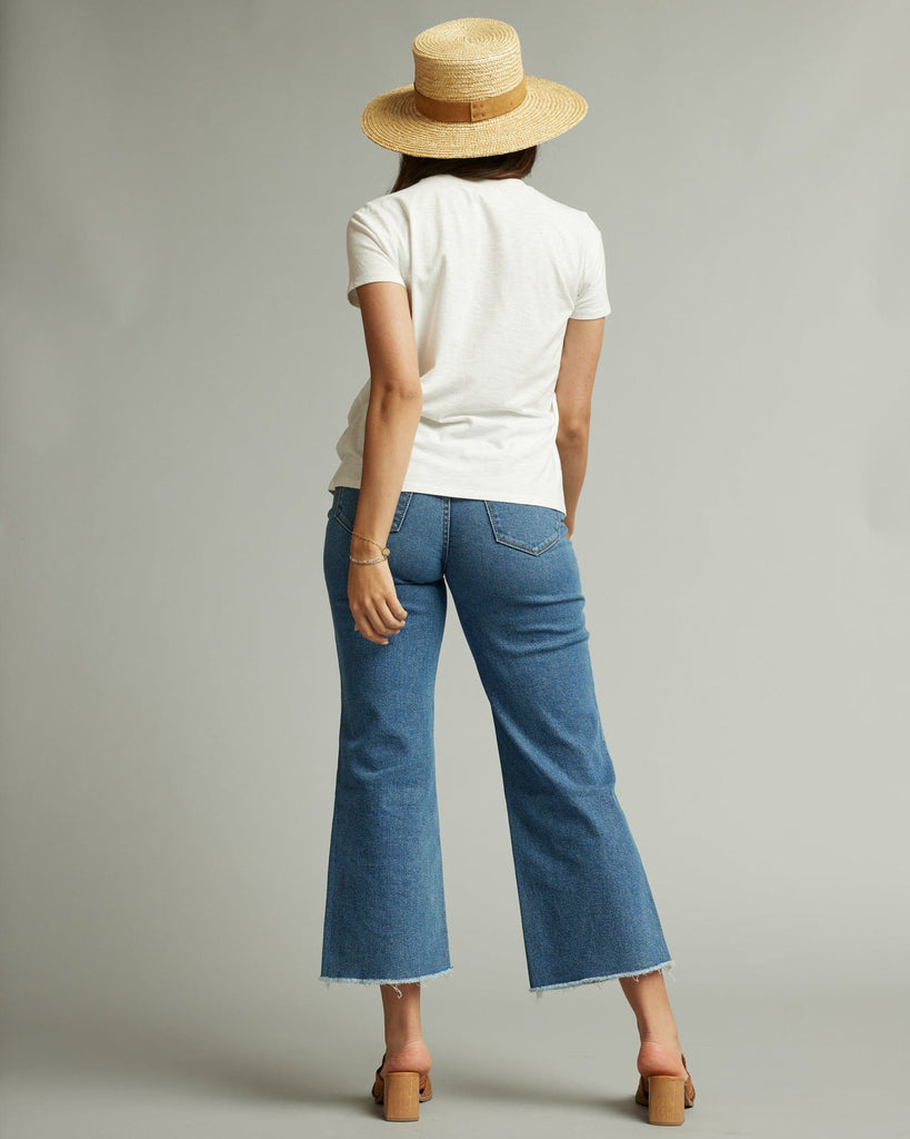 Woman in a short sleeve white graphic tee with a banana on the front