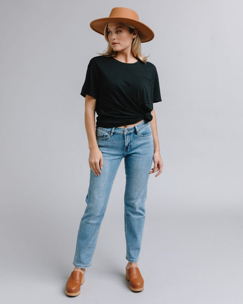 Woman in blue mid-rise straight jeans