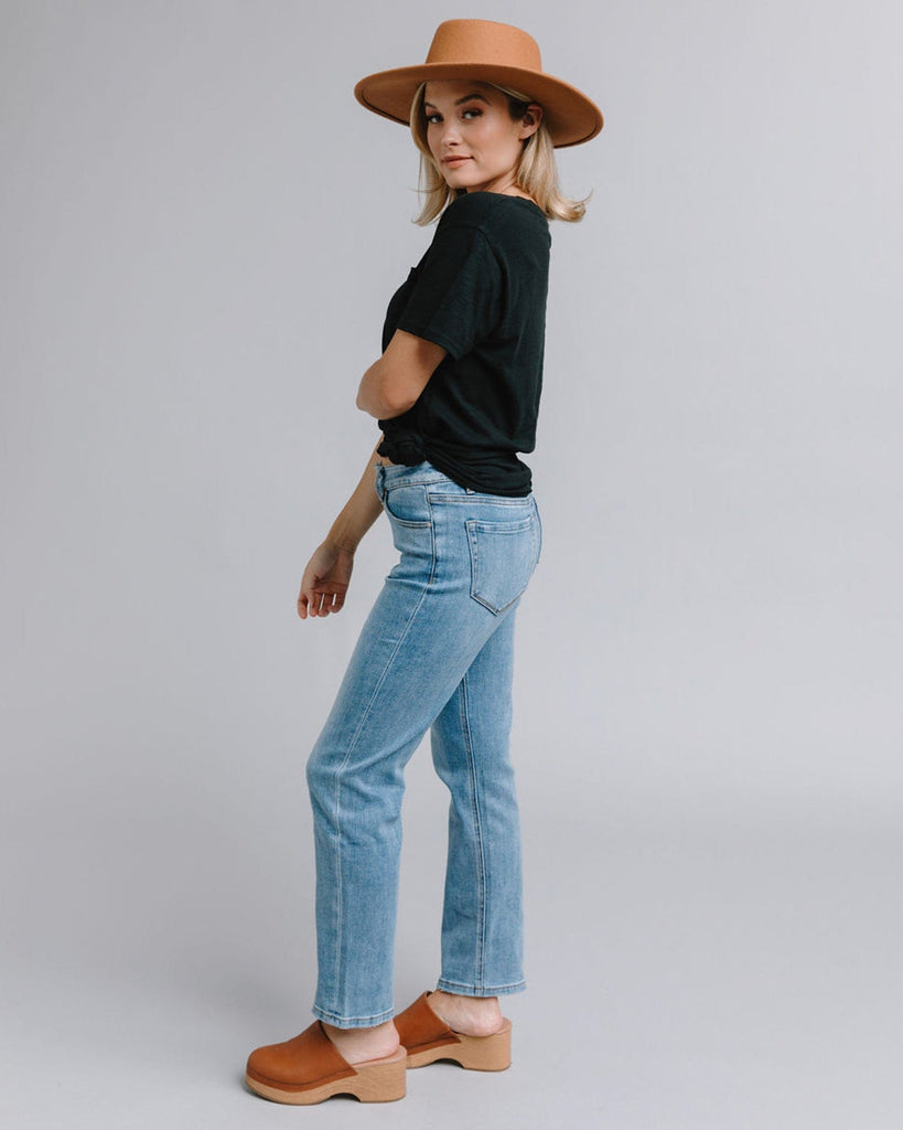 Woman in blue mid-rise straight jeans