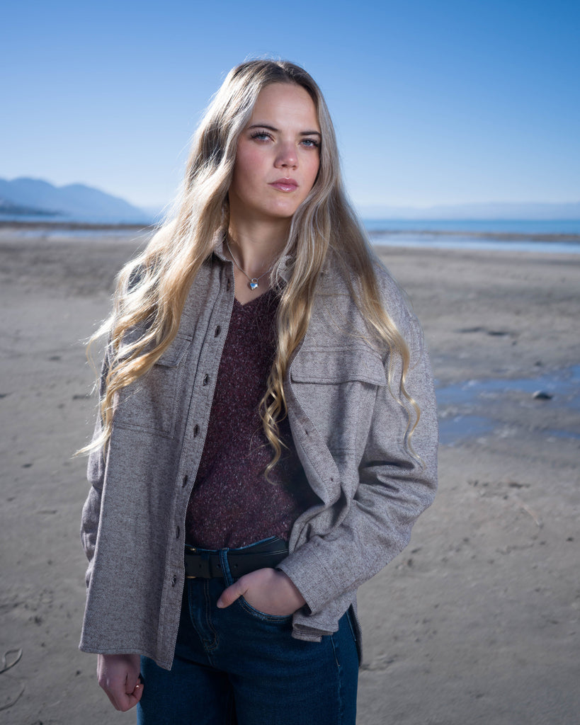 Woman in a brown long sleeve buttondown sweater