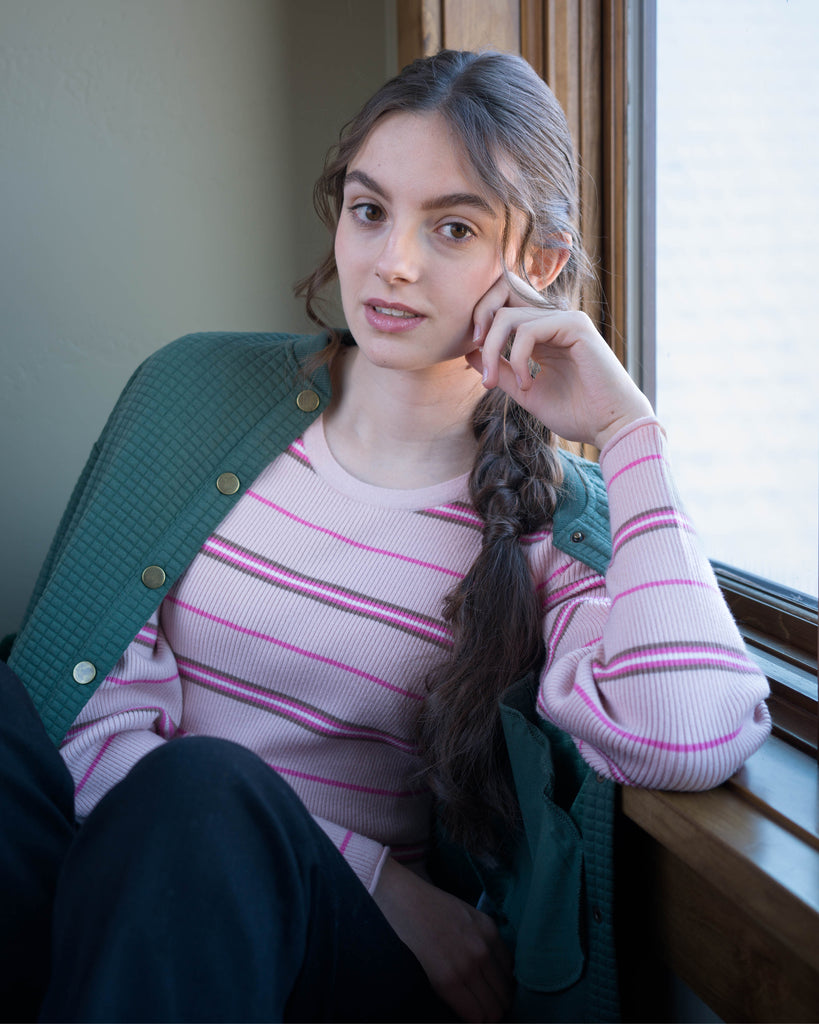 Woman in a pink striped long sleeve top