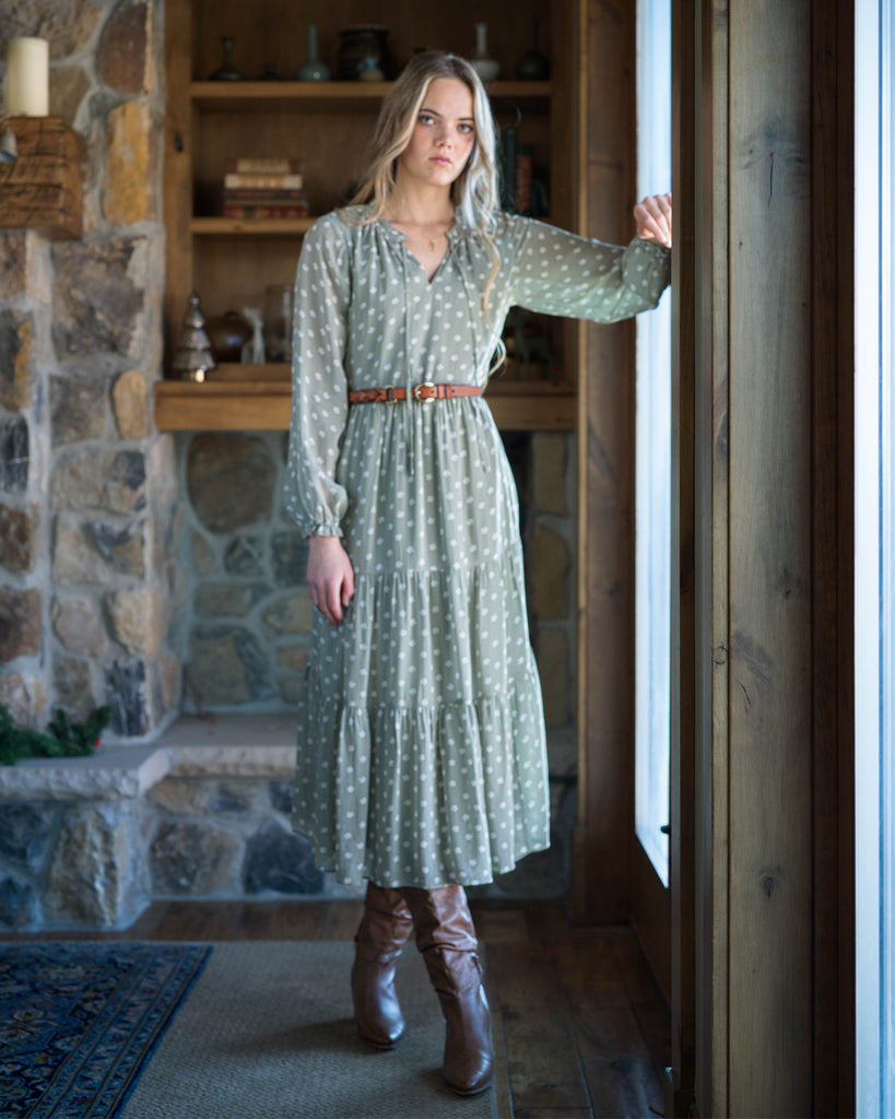 Woman in a green long sleeve midi-length dress