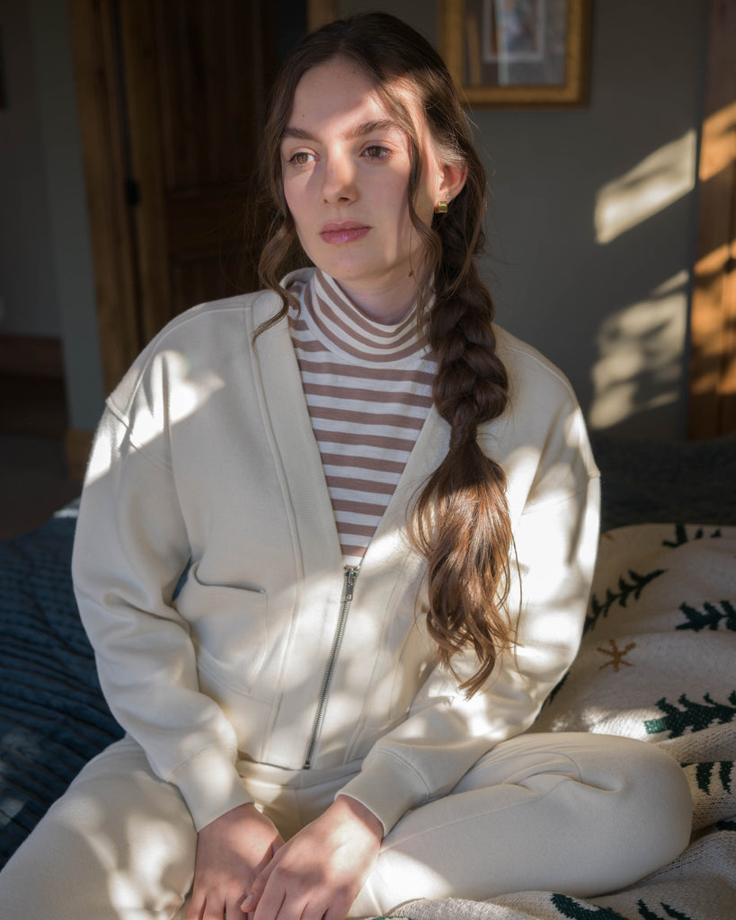 Woman in a white zip up sweatshirt