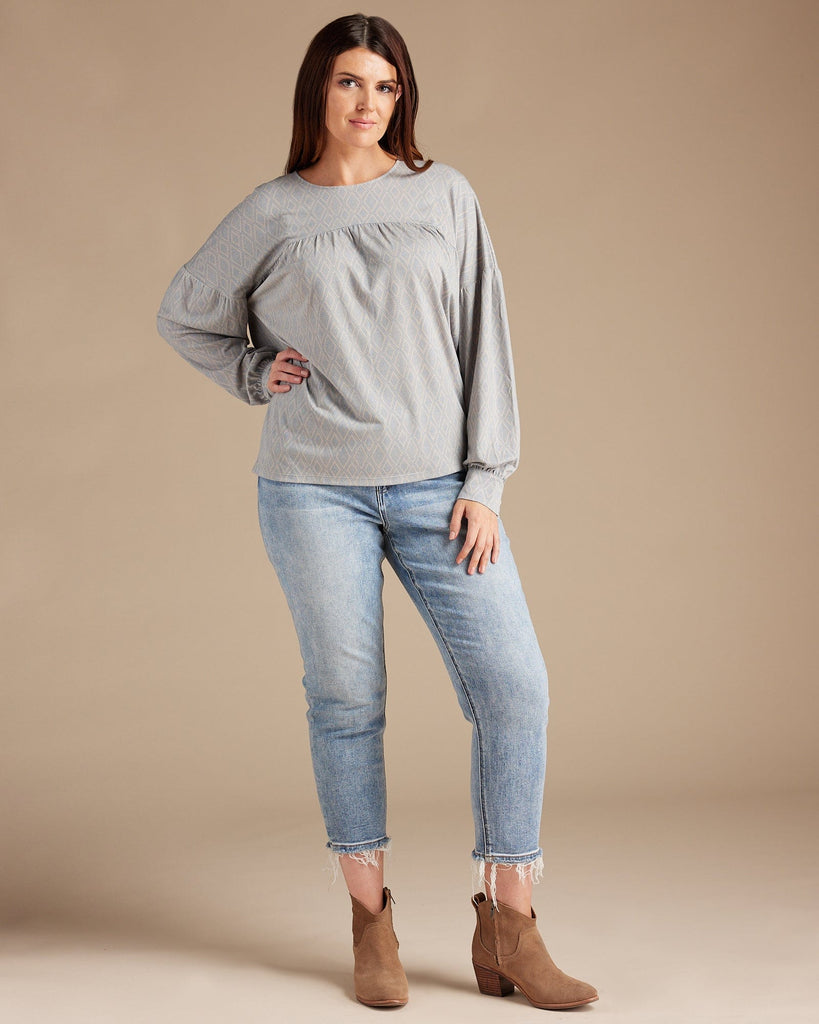 Woman in a gray long sleeve blouse