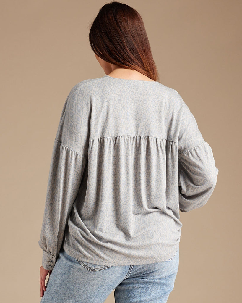 Woman in a gray long sleeve blouse