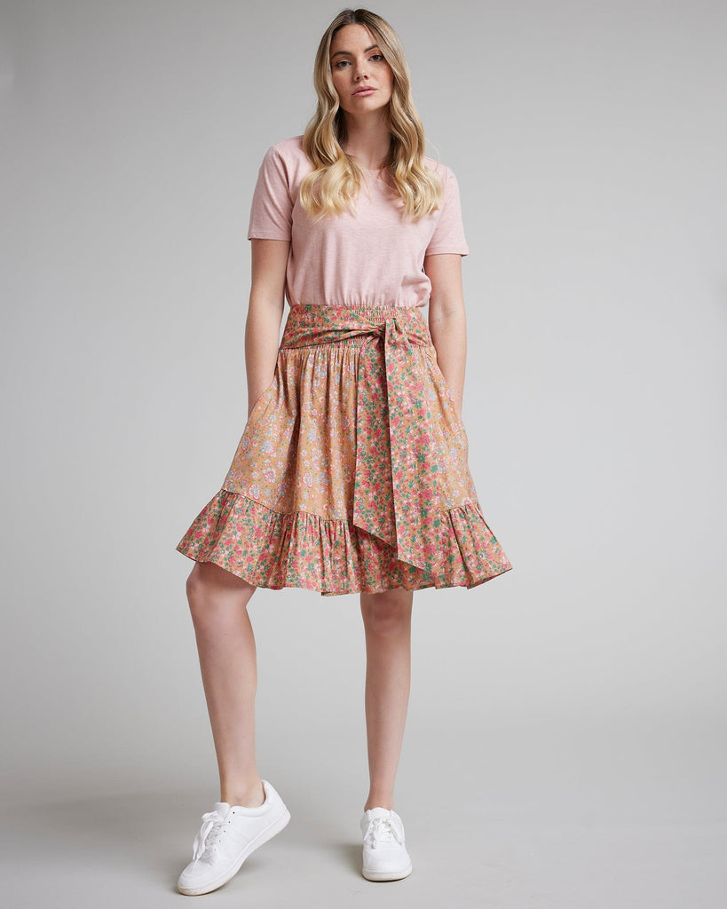 Woman in pink floral knee-length skirt