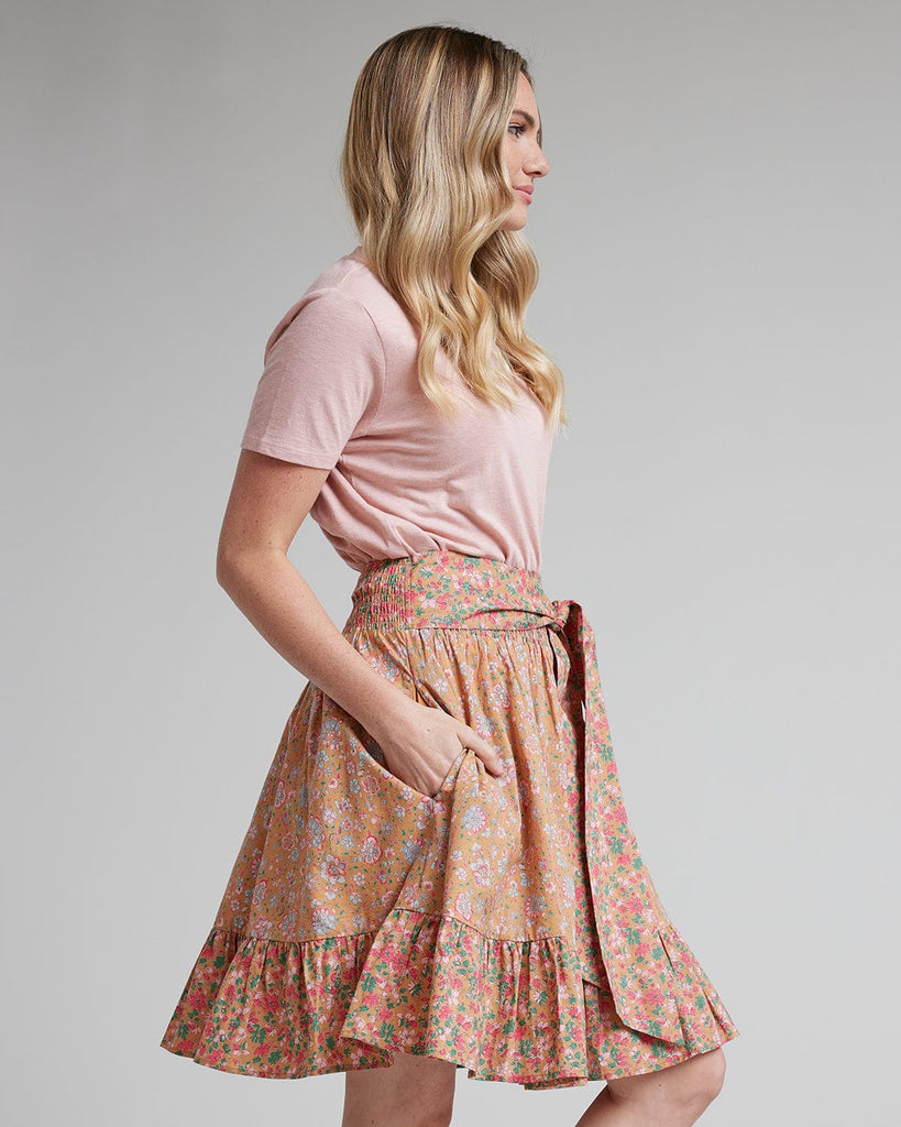 Woman in pink floral knee-length skirt