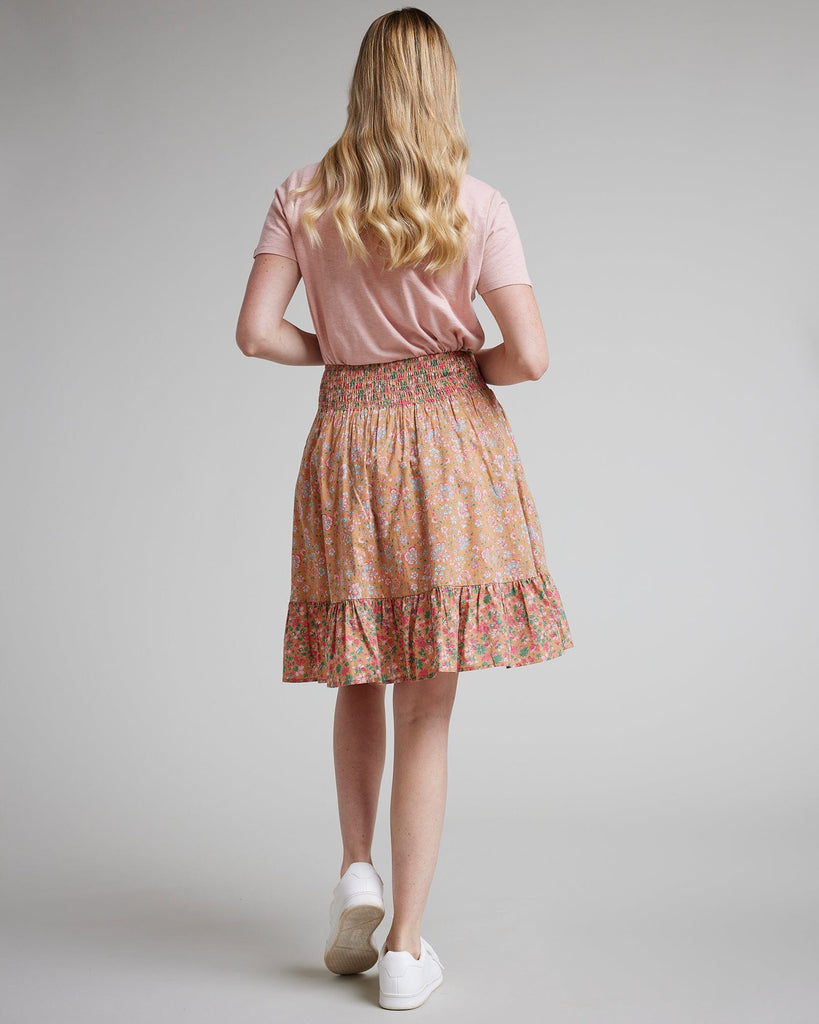 Woman in pink floral knee-length skirt