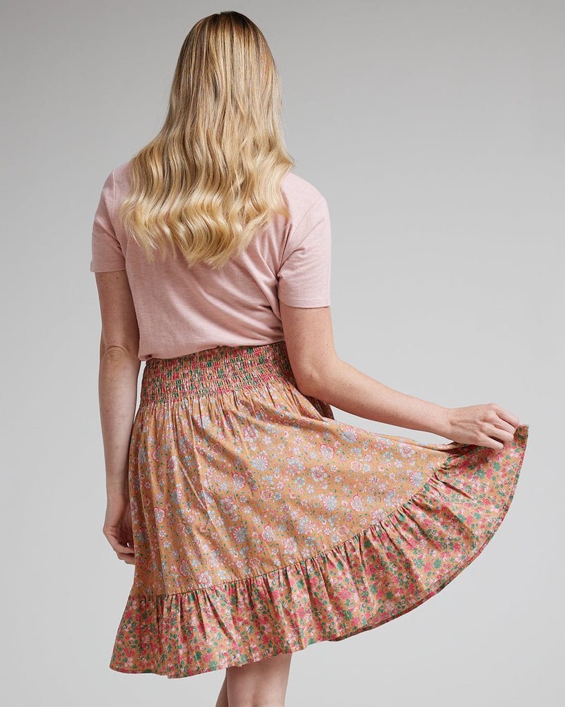 Woman in pink floral knee-length skirt