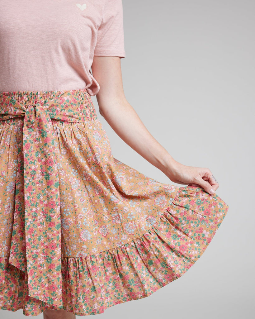 Woman in pink floral knee-length skirt