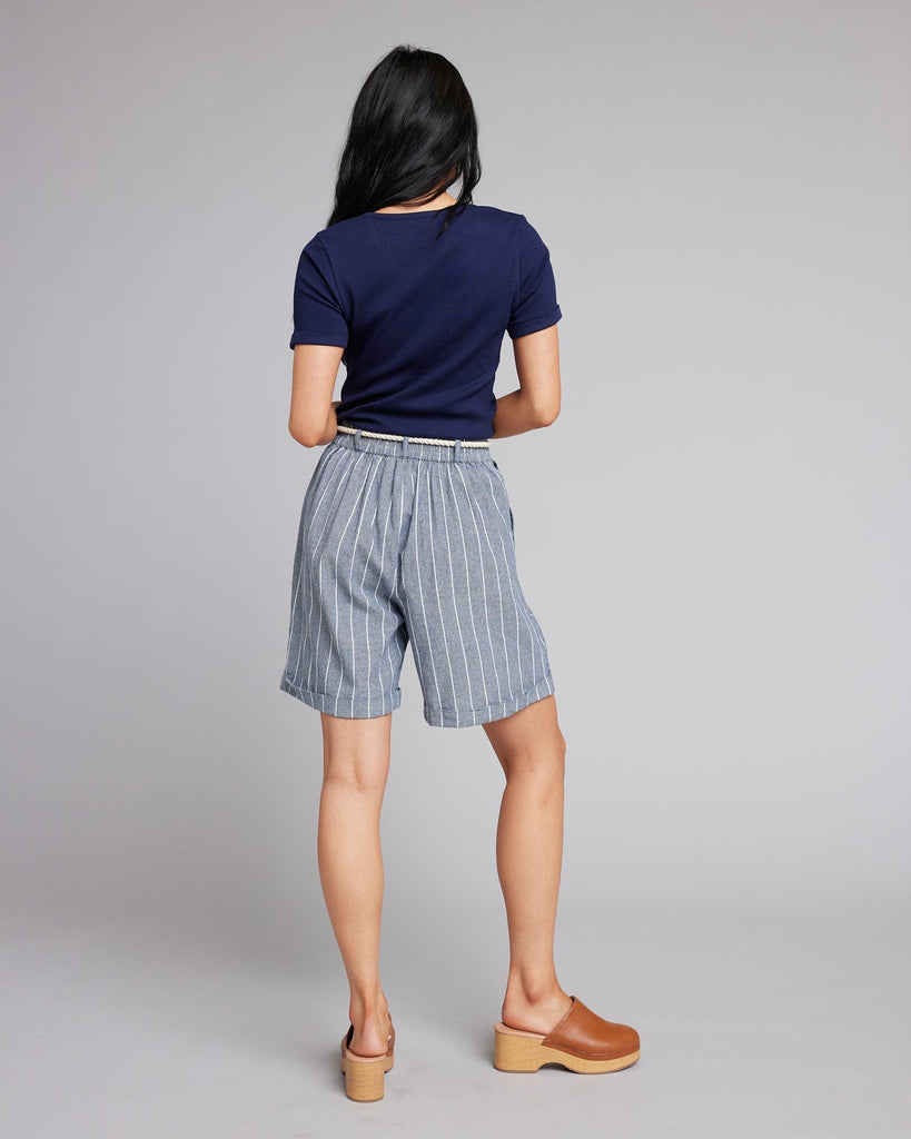 Woman in blue and white vertical striped shorts