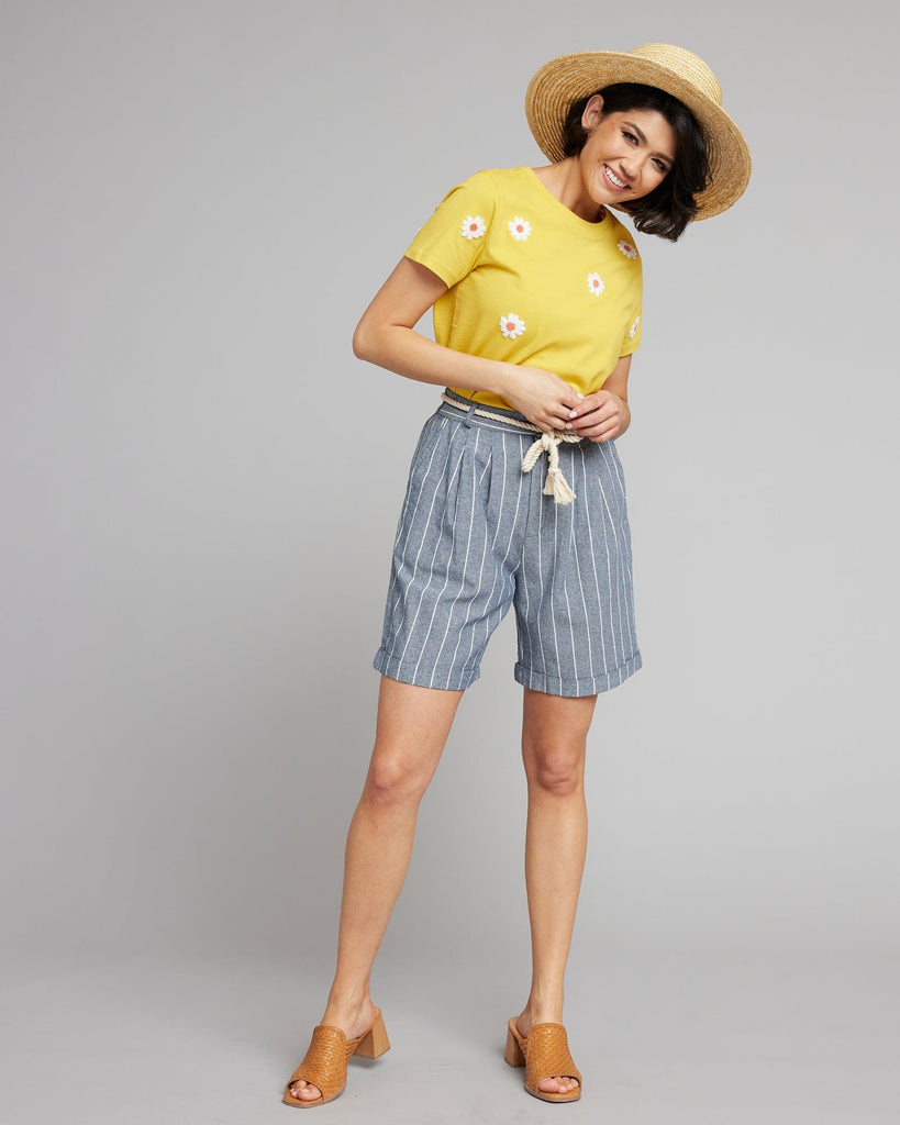 Woman in blue and white vertical striped shorts