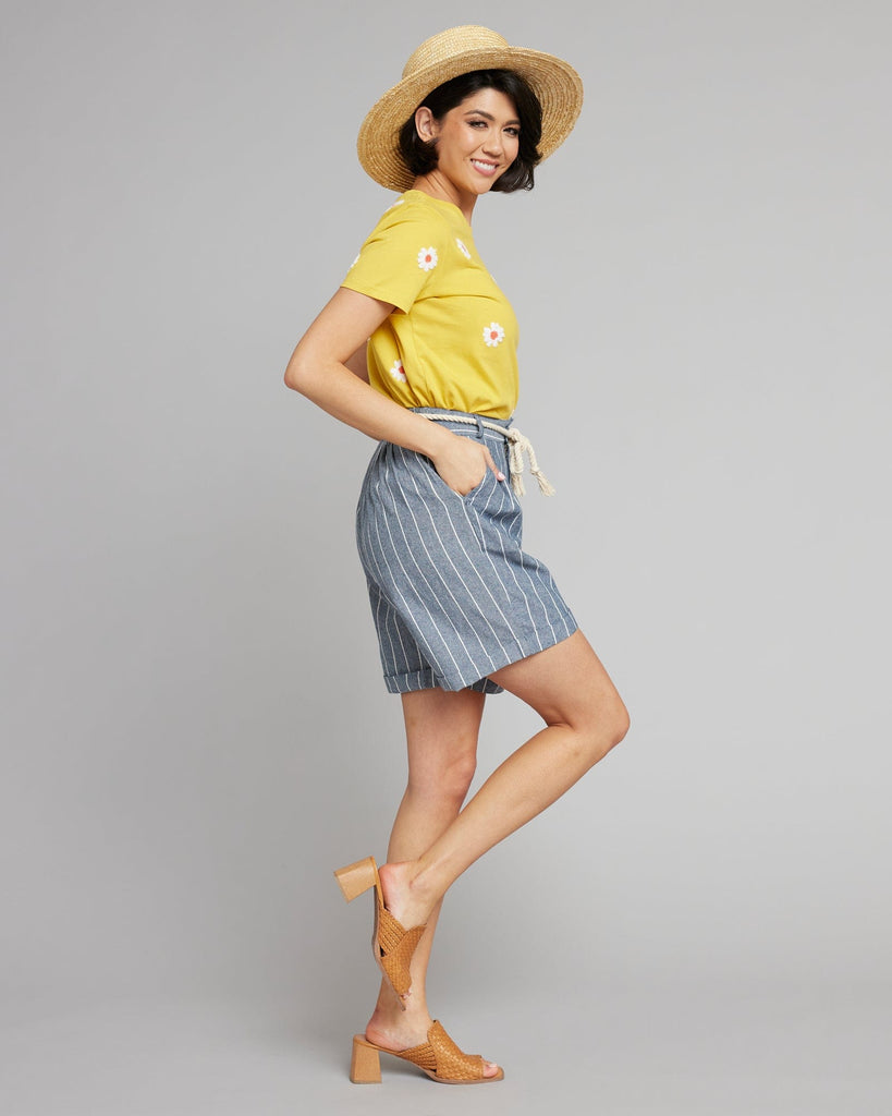 Woman in blue and white vertical striped shorts