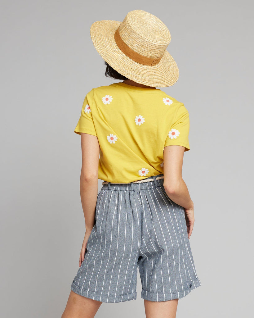 Woman in blue and white vertical striped shorts