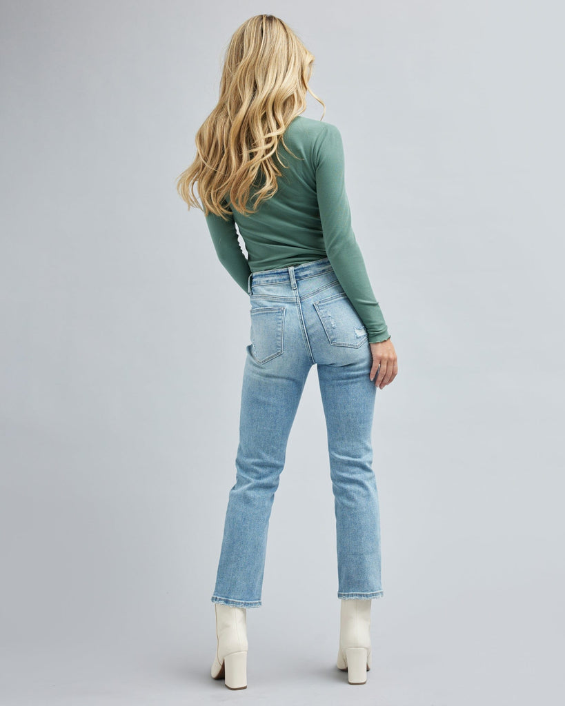 Woman in light blue jean, ankle length jean pants.