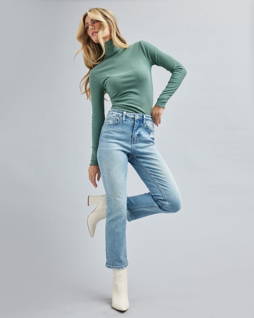 Woman in light blue jean, ankle length jean pants.