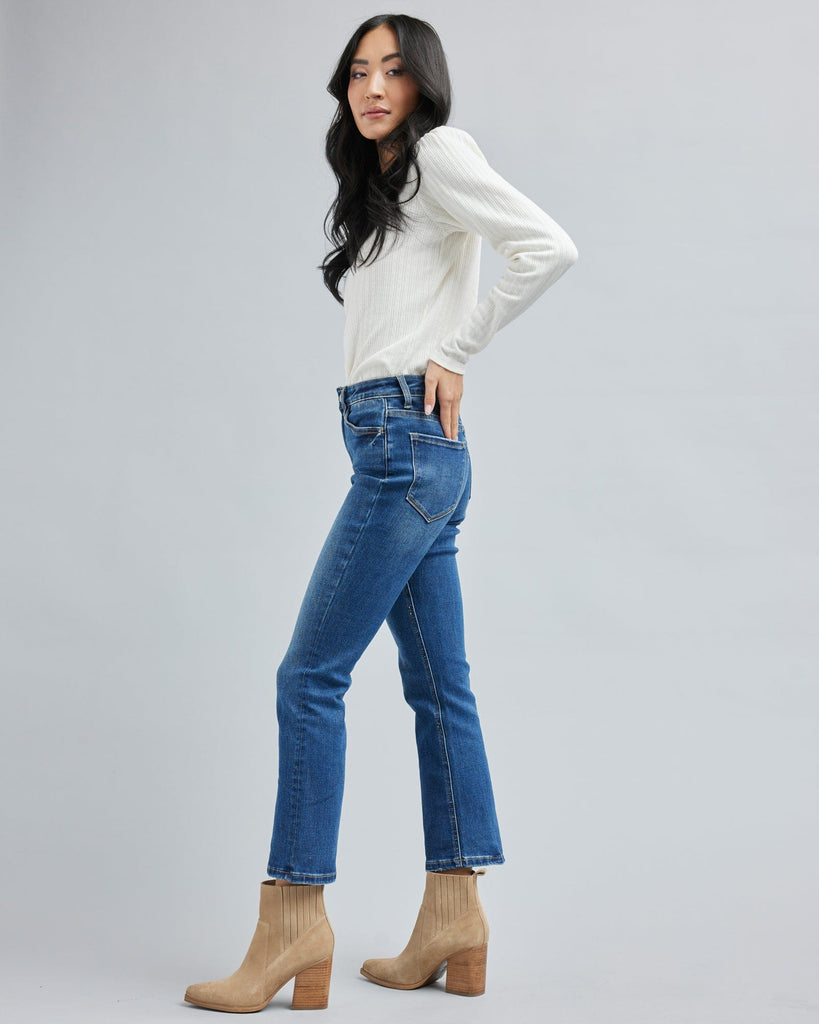 Woman in blue jean, ankle length denim pants.