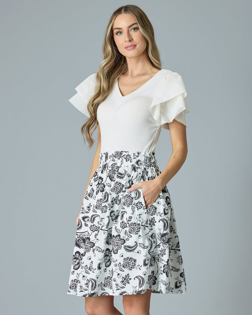 Model wearing a black and white paisley print knee-length flared skirt.