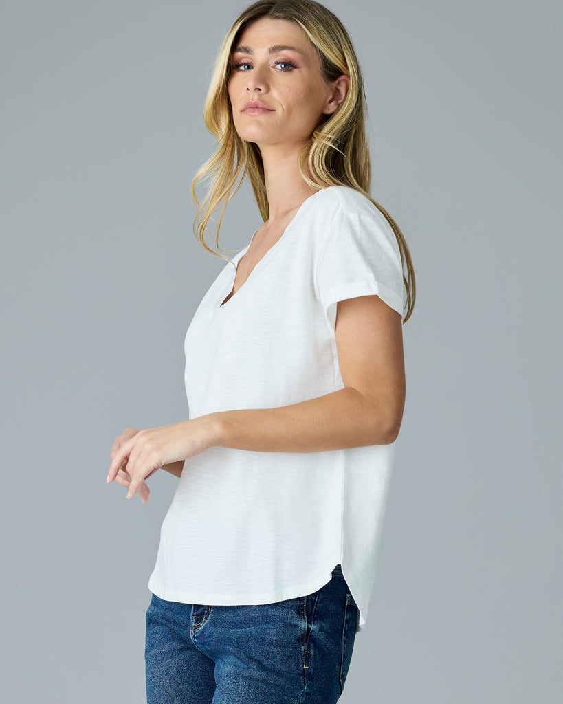 Woman in a white, short sleeve v-neck tee