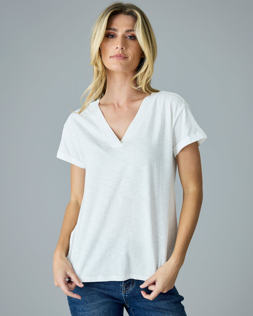 Woman in a white, short sleeve v-neck tee