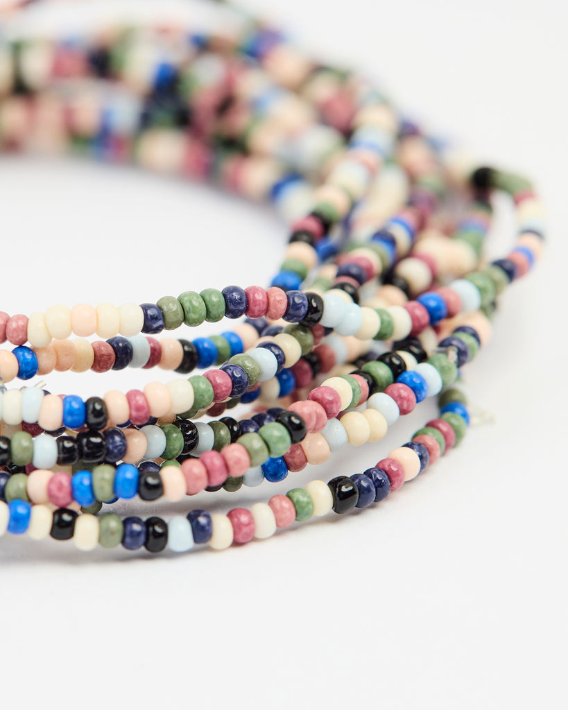 A set of beaded bracelets in various colors of orange, blue, green, black and white.