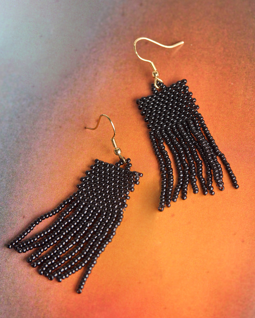 A pair of black beaded fringe earrings.