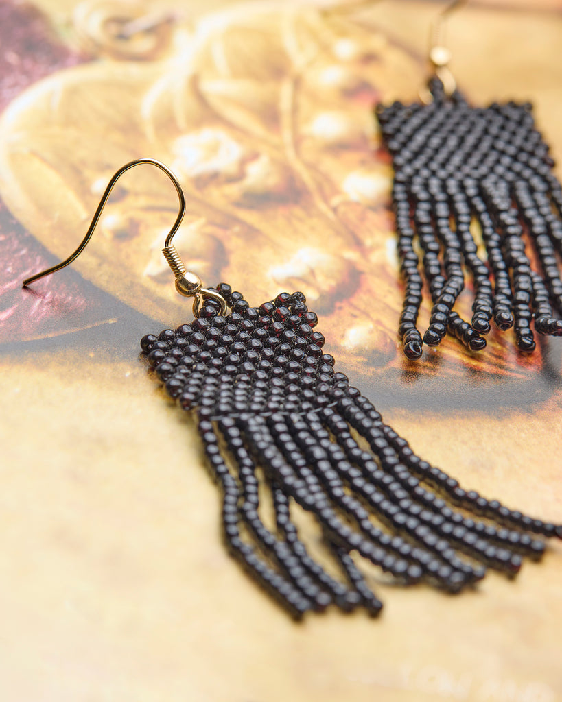 A pair of black beaded fringe earrings.