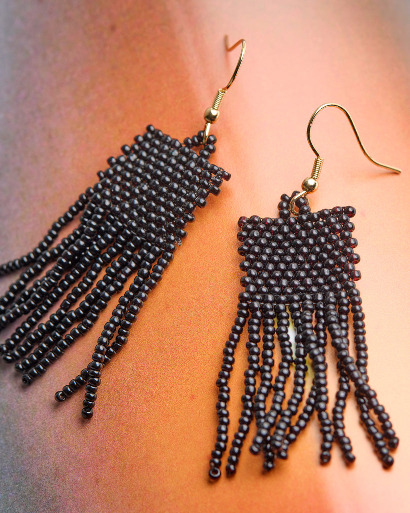 A pair of black beaded fringe earrings.