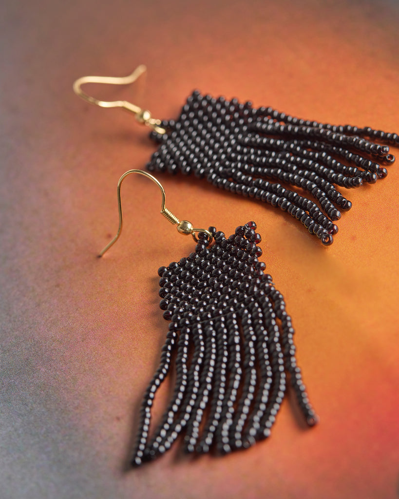 A pair of black beaded fringe earrings.