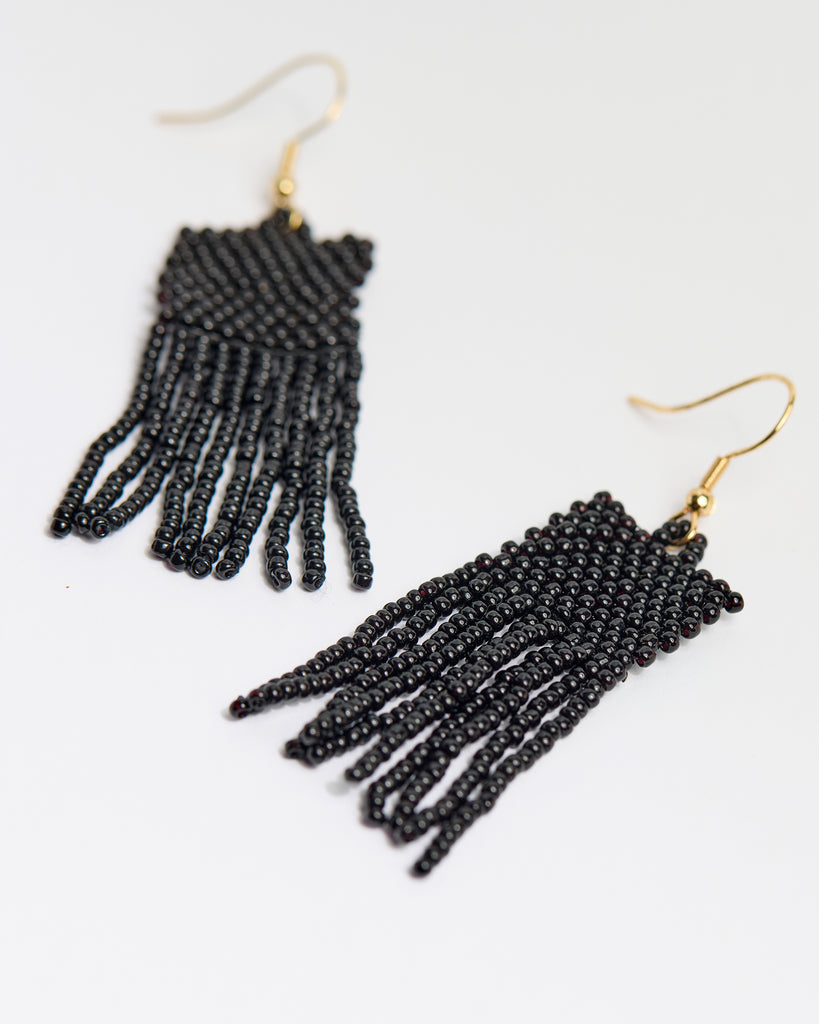 A pair of black beaded fringe earrings.