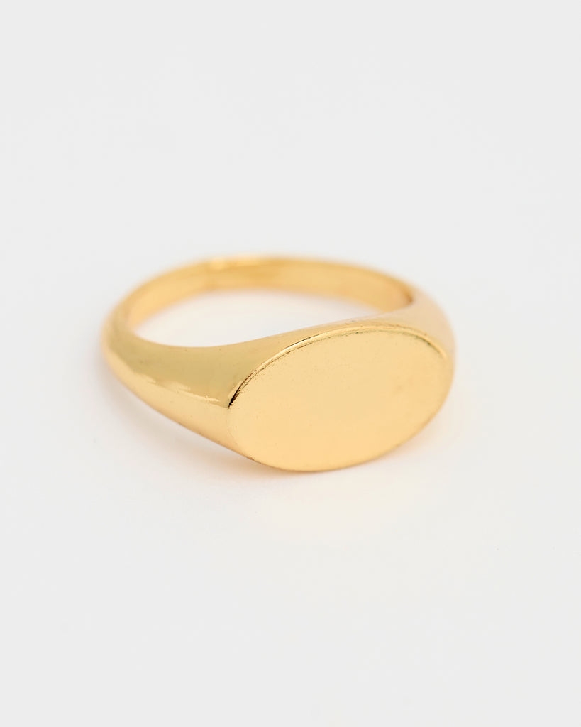 A gold ring with a circular plain signet. 