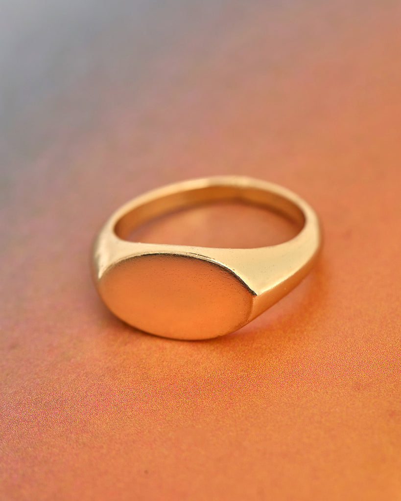 A gold ring with a circular plain signet. 