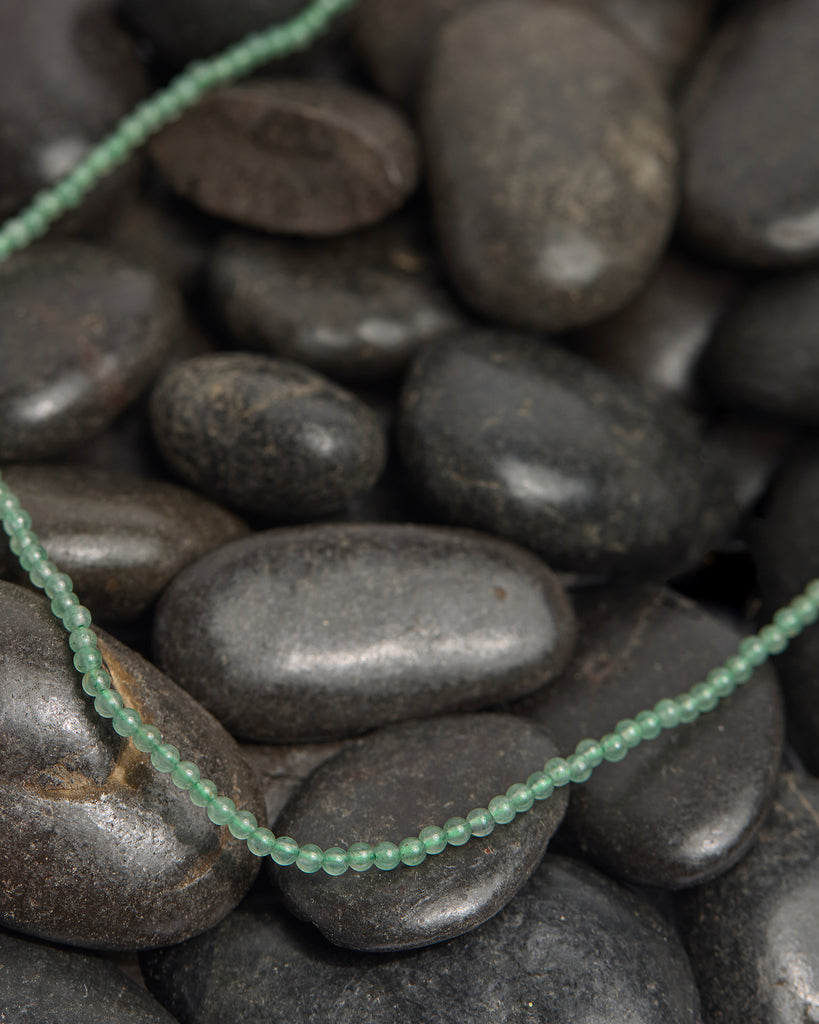 A light green beaded necklace.