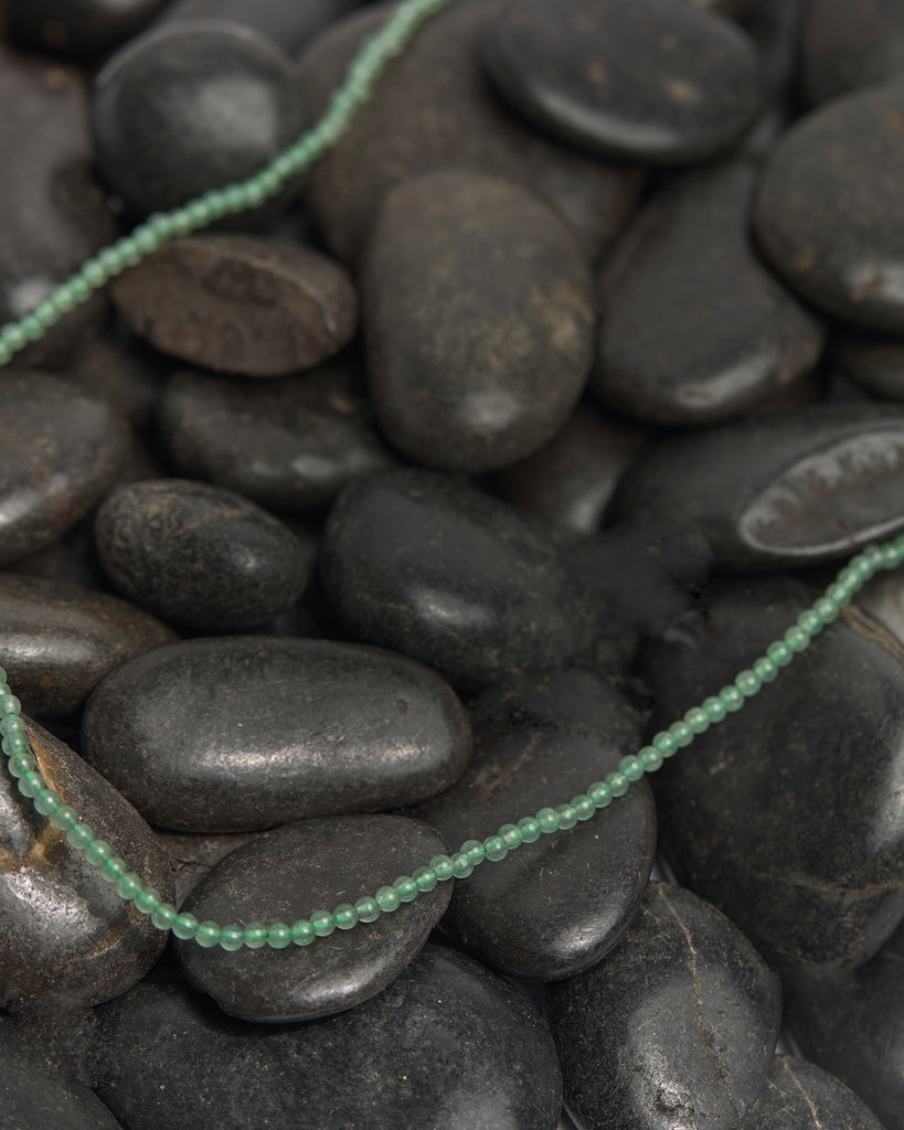 A light green beaded necklace.