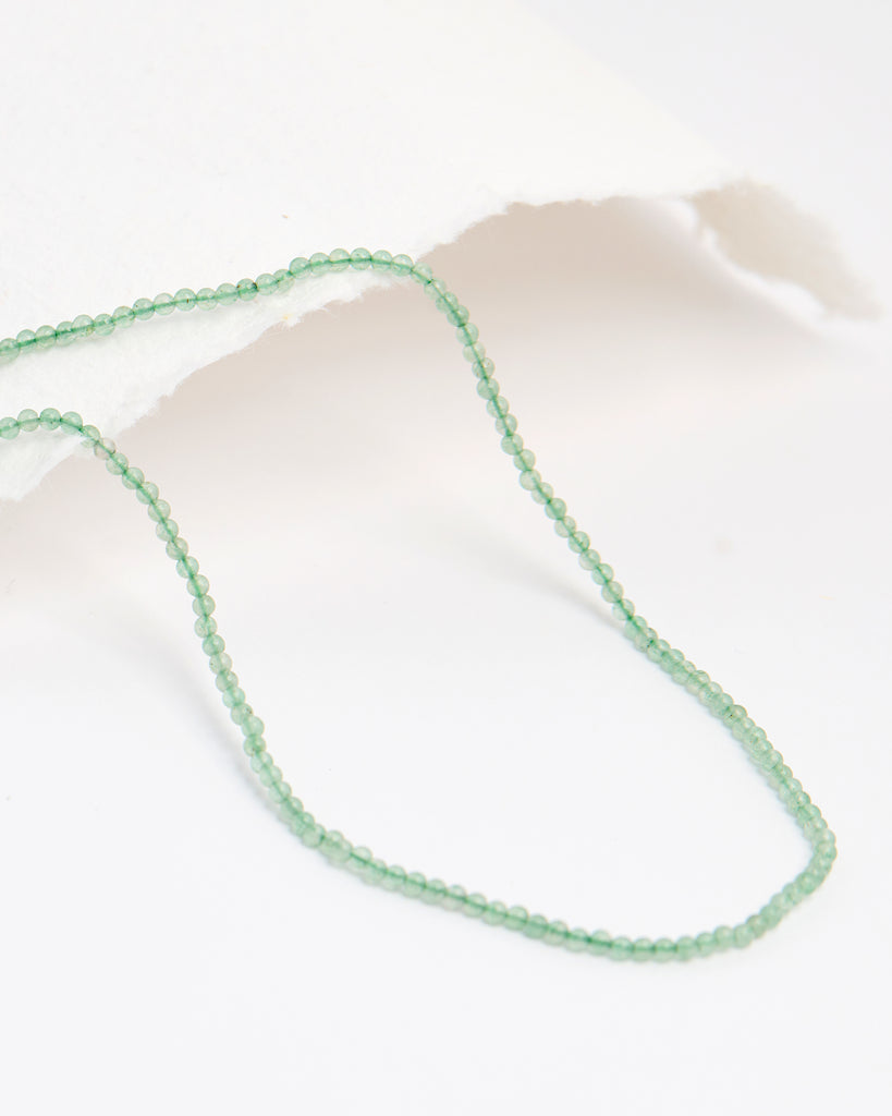 A light green beaded necklace.