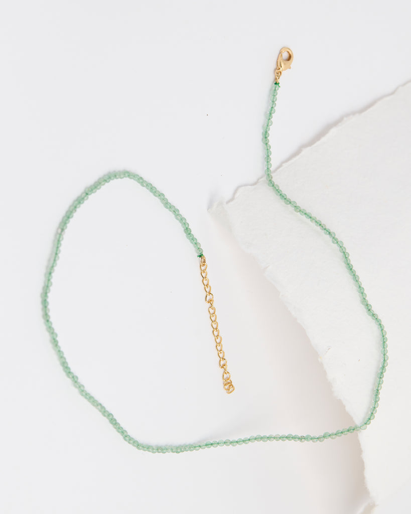 A light green beaded necklace.