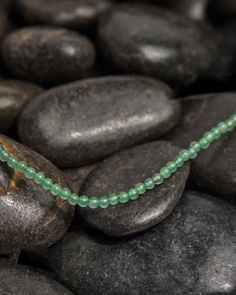 A light green beaded necklace.