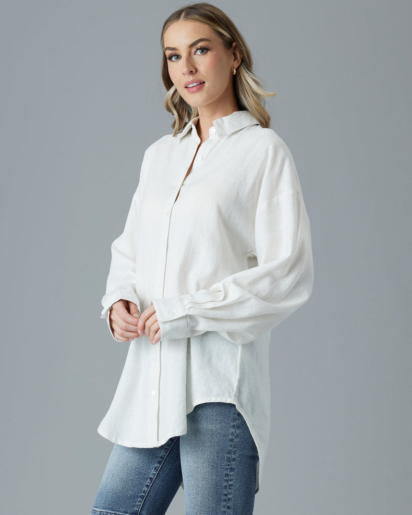 Woman in a white, over-sized, long sleeve buttondown