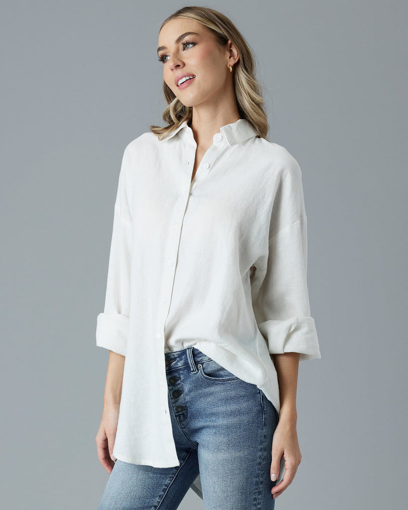 Woman in a white, over-sized, long sleeve buttondown