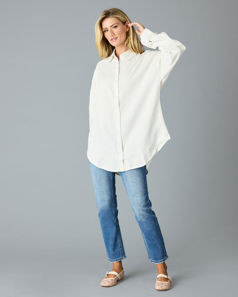 Woman in a white, over-sized, long sleeve buttondown