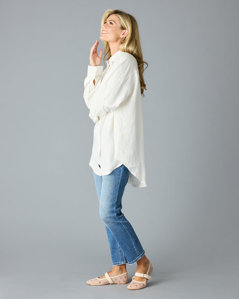 Woman in a white, over-sized, long sleeve buttondown