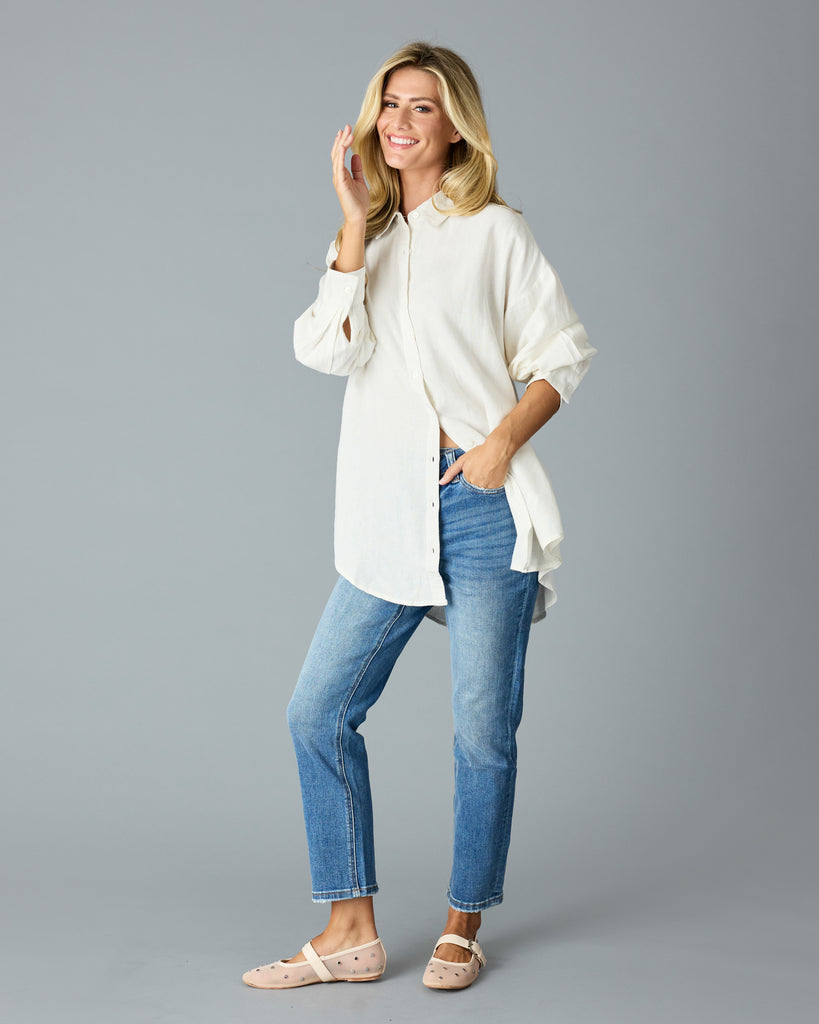 Woman in a white, over-sized, long sleeve buttondown