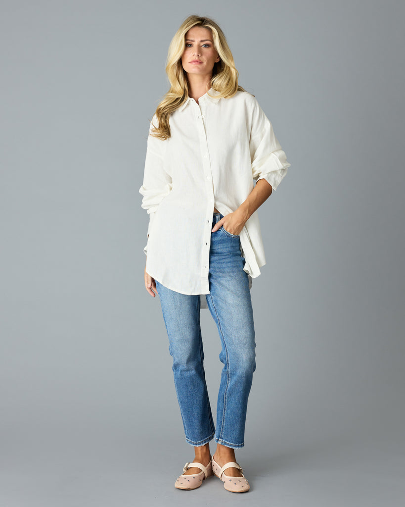 Woman in a white, over-sized, long sleeve buttondown