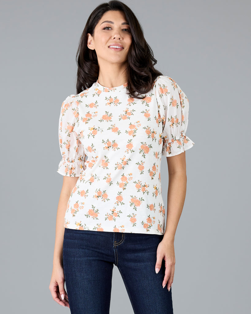 Woman in a short sleeve floral print top