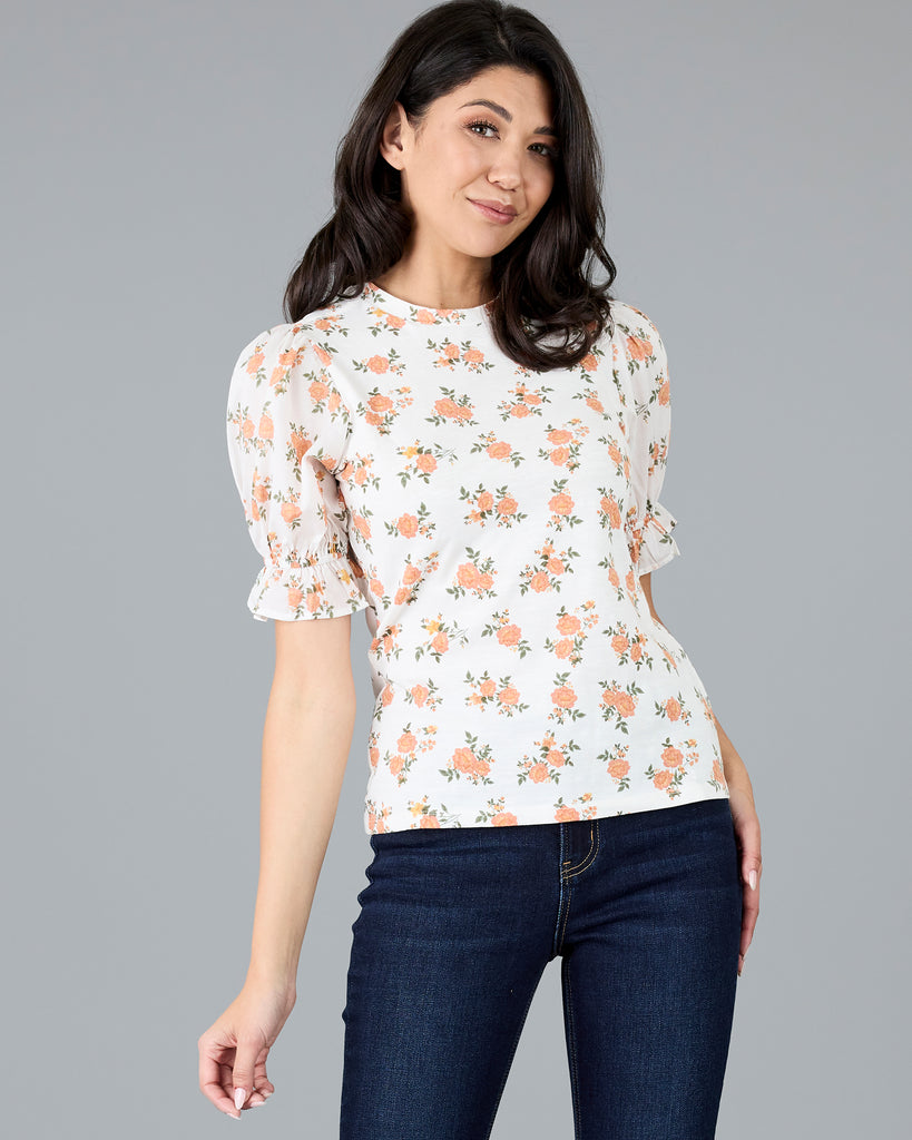 Woman in a short sleeve floral print top