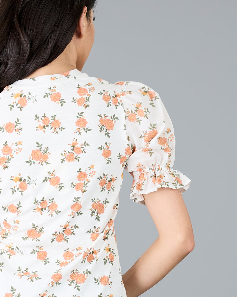 Woman in a short sleeve floral print top