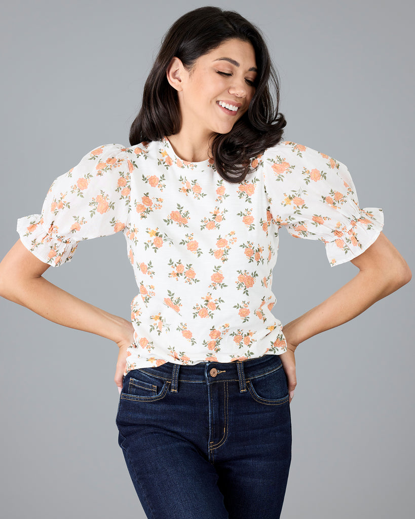 Woman in a short sleeve floral print top