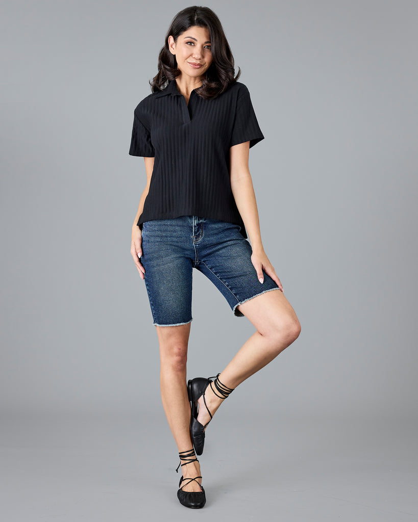 Woman in a black short sleeve polo